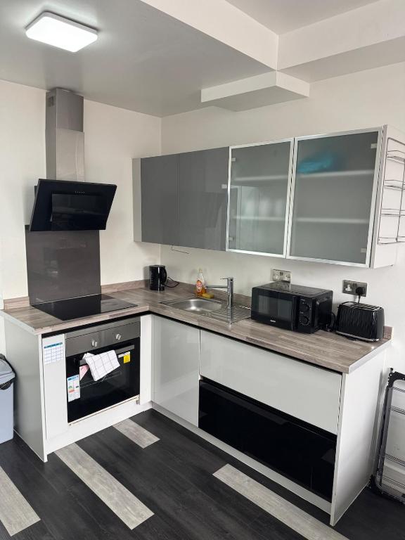a kitchen with a counter top and a microwave at One bed flat Northampton Town 5 in Northampton