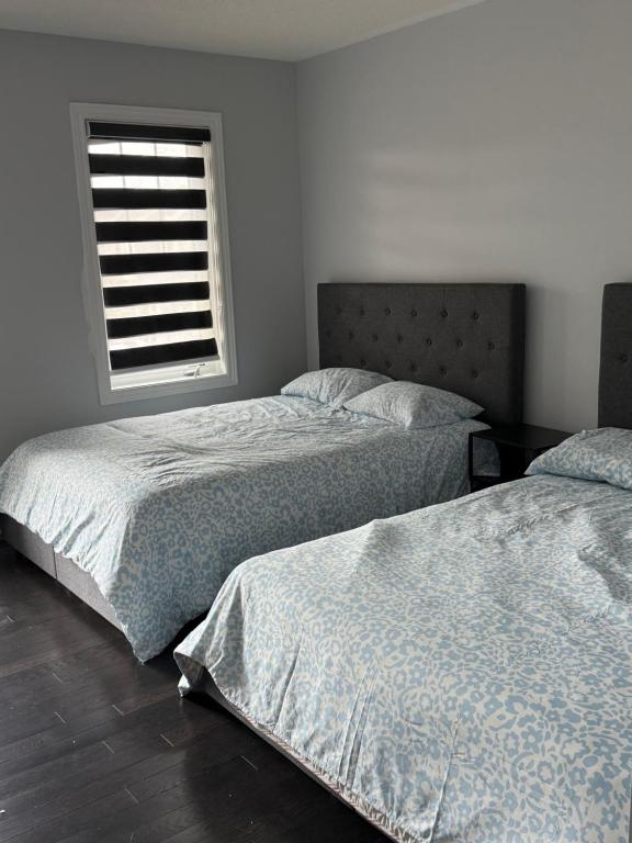 two beds in a bedroom with a window at One Bet room in Whitby