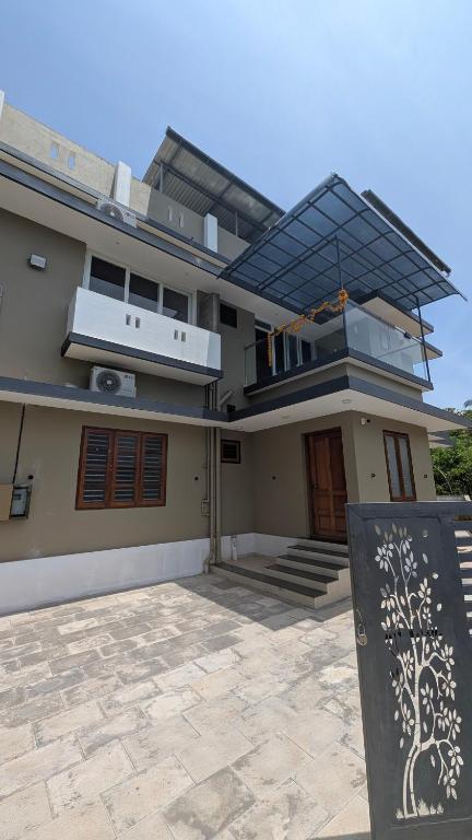 a large house with a balcony and a roof at Grand Beach Villa in Kannur