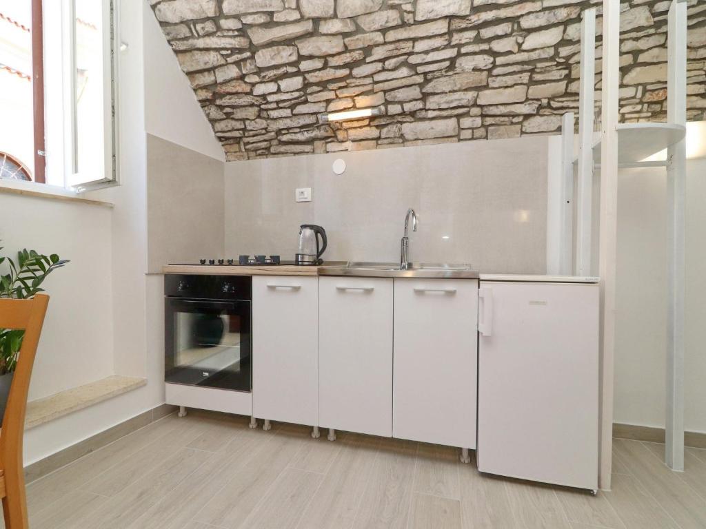 a kitchen with a sink and a stove at Studio Jokovi - Studio Apartment with Terrace and City View in Vela Luka
