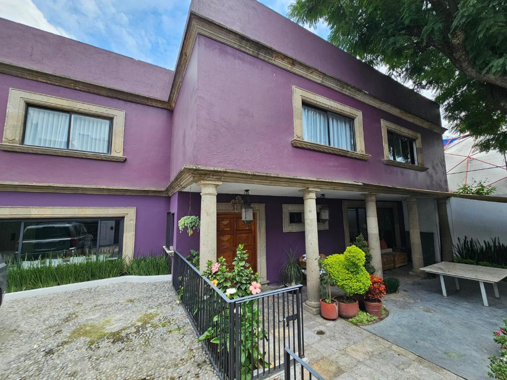 una casa viola con una panchina davanti di Casa Monasterio H Boutique a Città del Messico