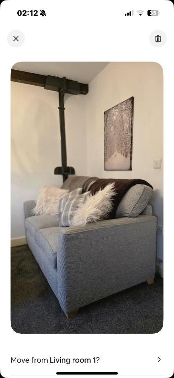 a dog laying on a couch in a living room at Sensinhome in Dover