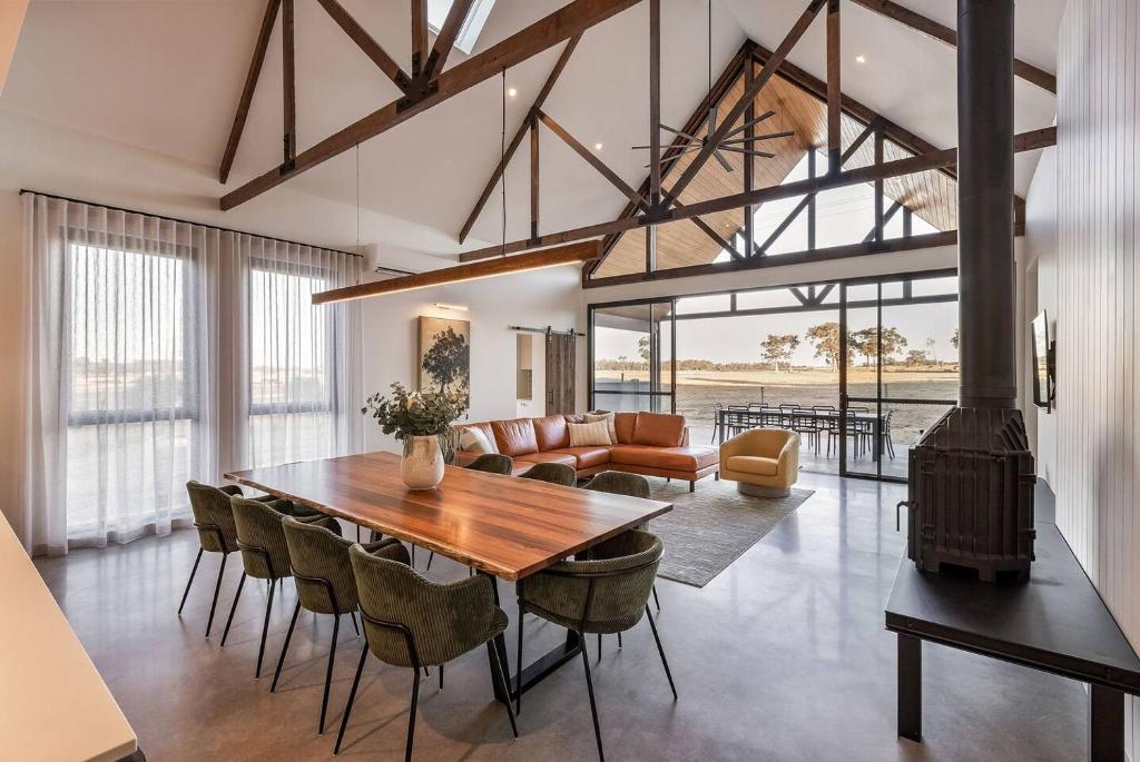a dining room with a table and a fireplace at The Cheese Factory - Luxe Design & Wine Country Calm in Cowaramup