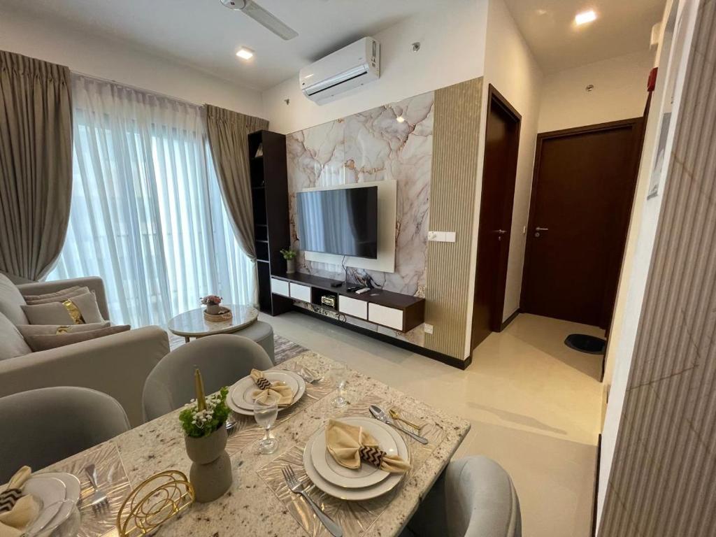 a living room with a dining table and a television at Colombo Trizen Nuva Apartments in Colombo