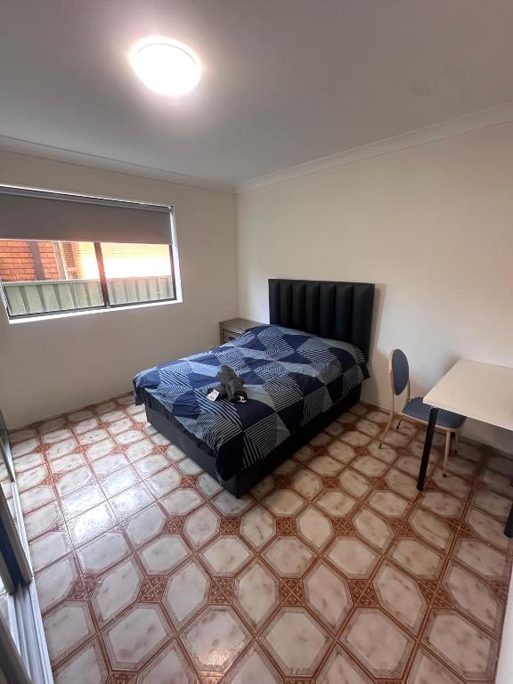 a bedroom with a bed with a stuffed animal on it at Spacious Queen Room in Comfortable Two Story House - L2 