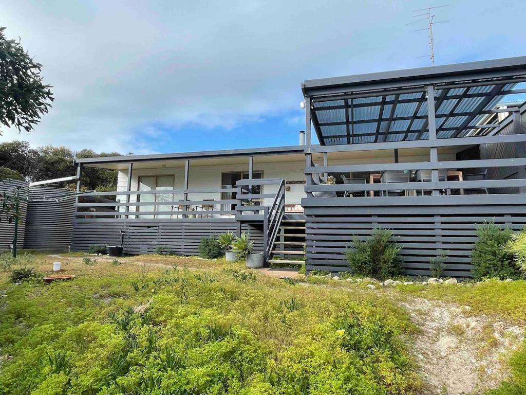 a house with a balcony on the side of it at Southside at Vivonne in Vivonne Bay