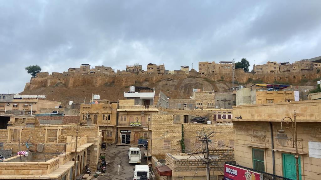 a group of buildings in front of a mountain at Hotel Heaven In Jaisalmer in Jaisalmer