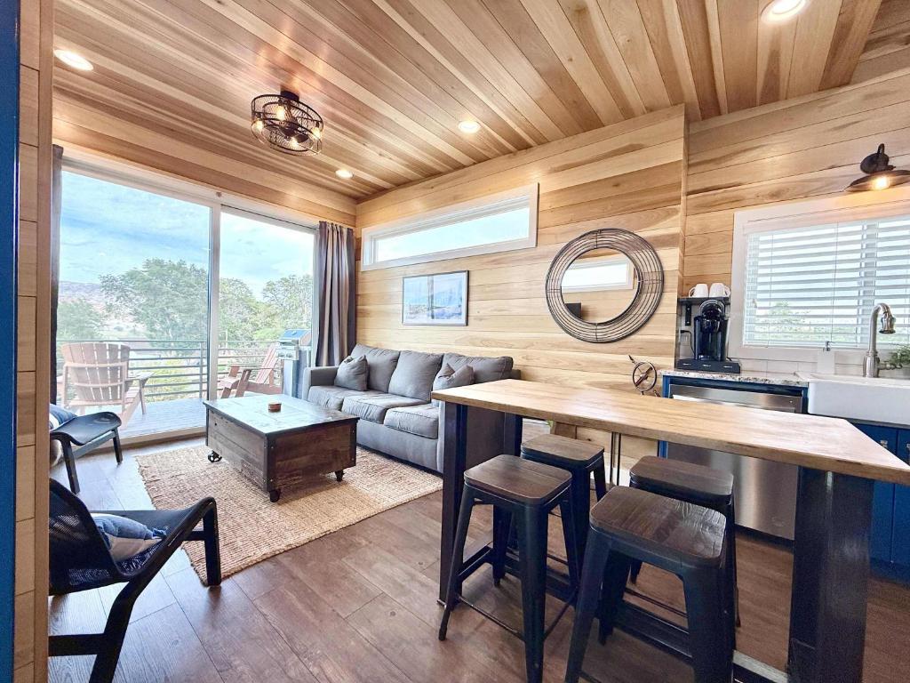 a kitchen and living room with a table and a couch at Escalante Escapes Fox Tail- Loft Escape in Escalante