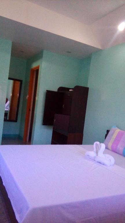 Postel nebo postele na pokoji v ubytování SUNSHINE PARADISE Inn