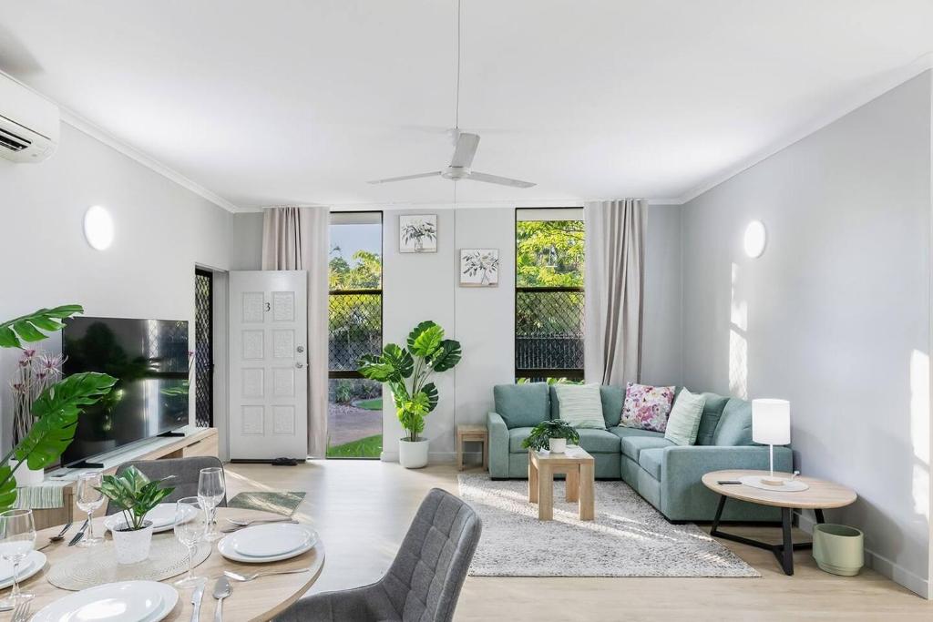 a living room with a couch and a table at Sandalwood Oasis - Tropical Serenity near Waterfront in Nightcliff