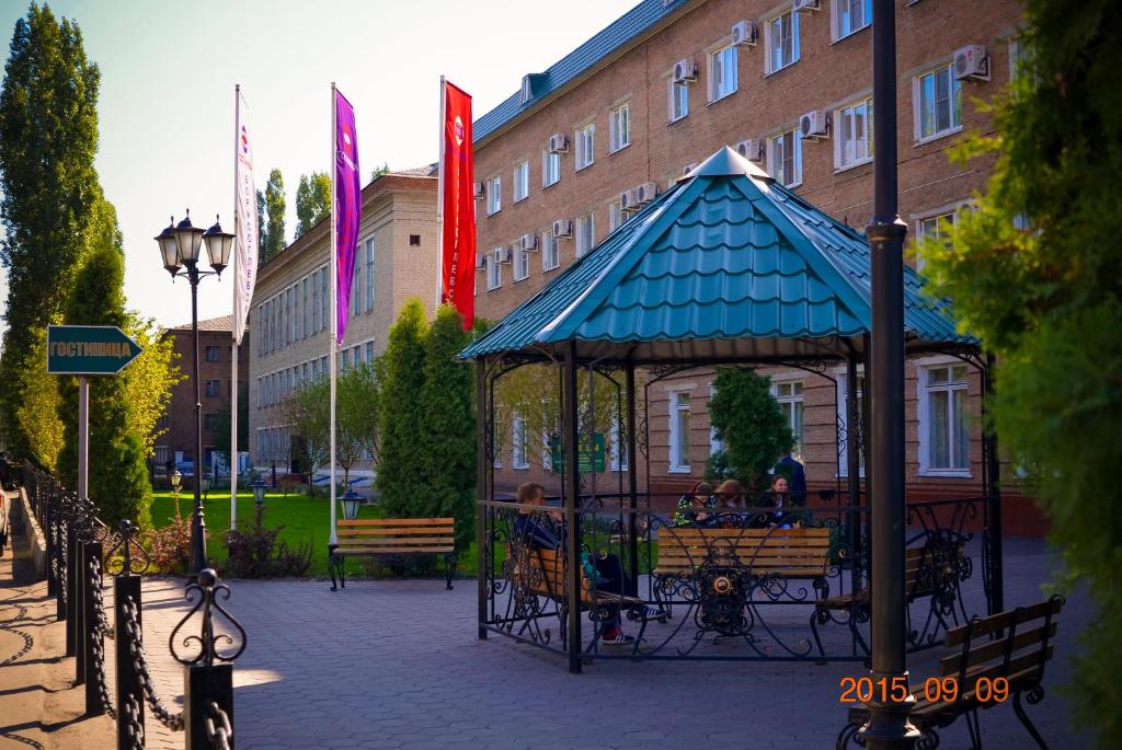 a gazebo with people sitting in it in front of a building at Hotel Borisoglebsk in Borissoglebsk