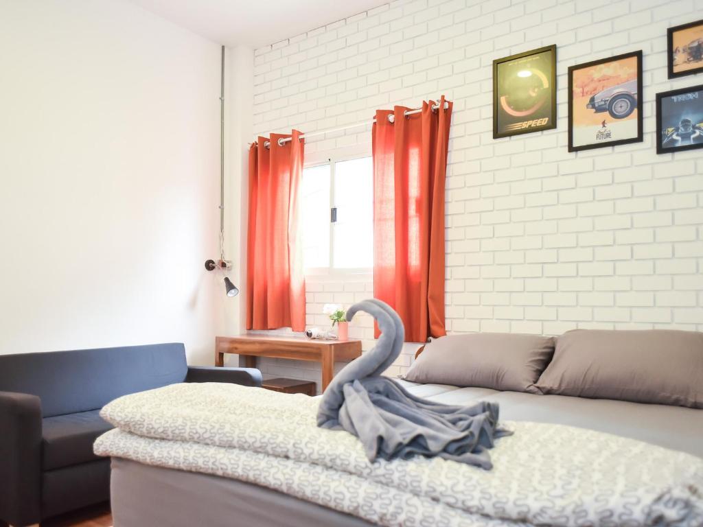 um quarto com uma cama com uma estátua de cisne em The Garage em Chiang Rai