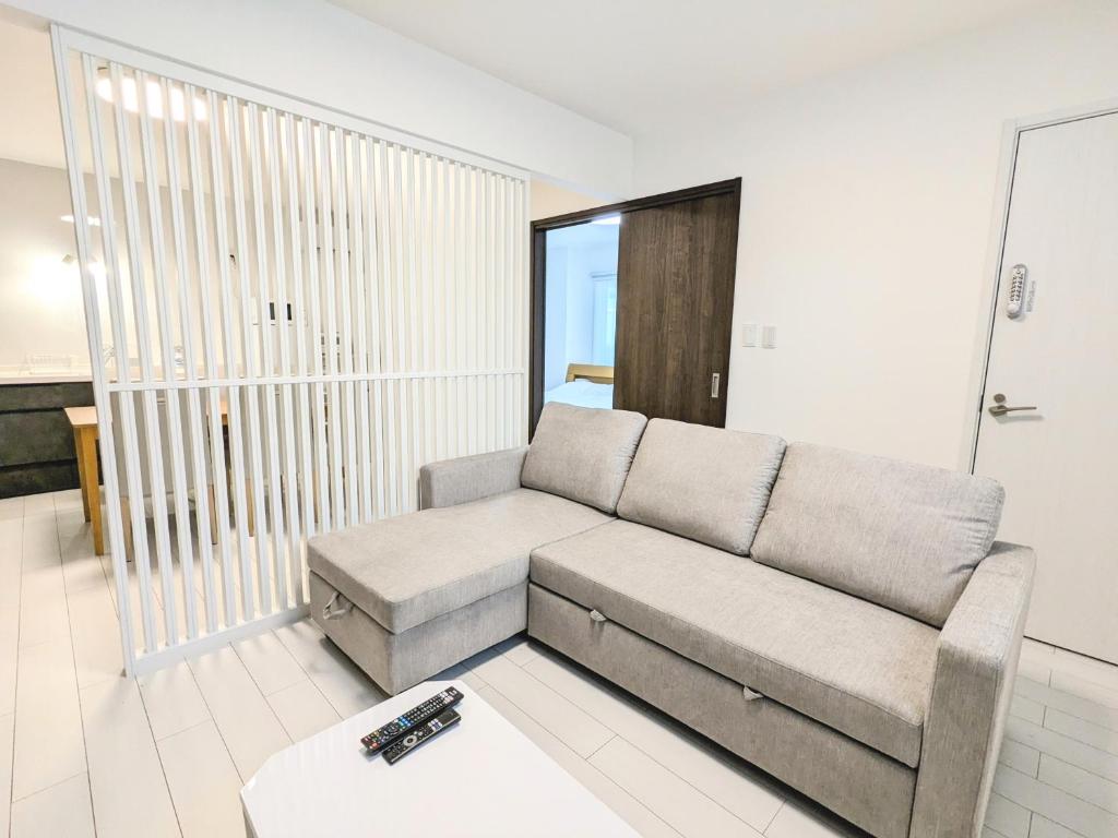 a living room with a couch and a table at Vacation House 3 in Funabashi