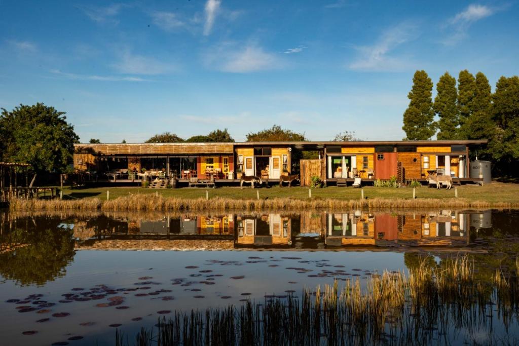 a building with a lake in front of it at ECO Lodge Villa Villekula in The Crags
