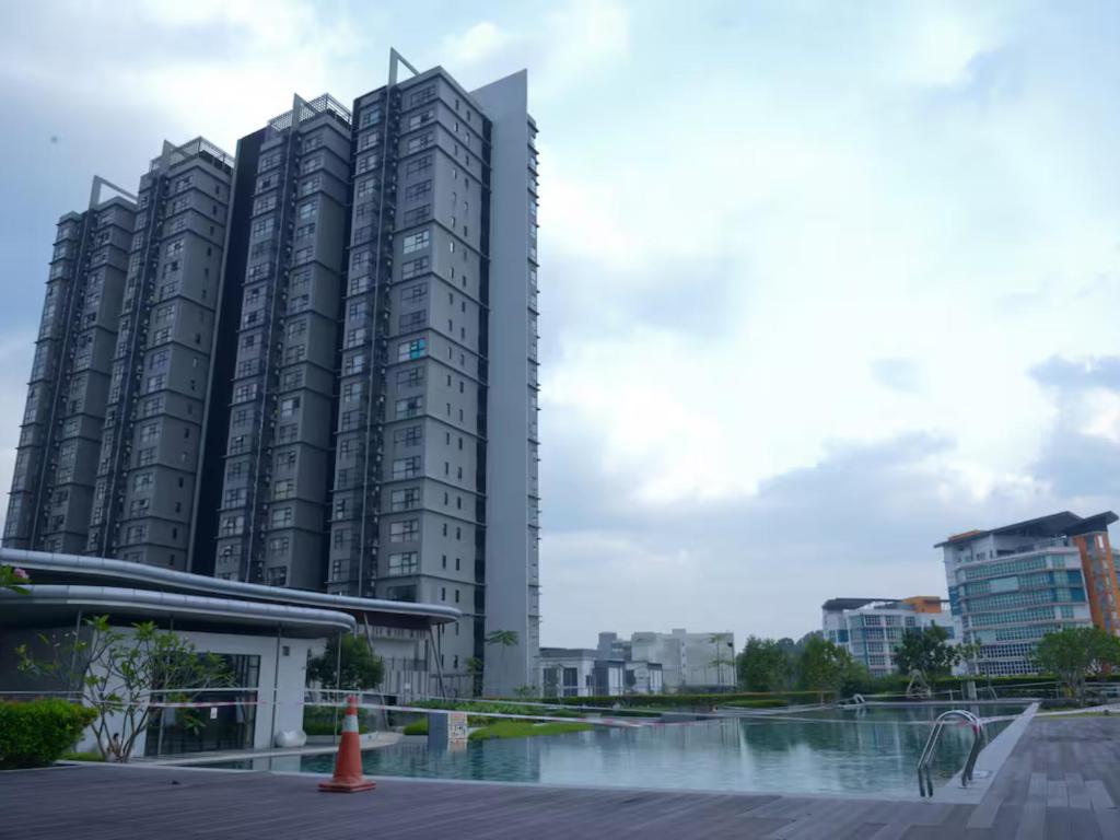 a group of tall buildings in a city at IdamanKu Comfort Apartment - HYVE SOHO Cyberjaya in Cyberjaya