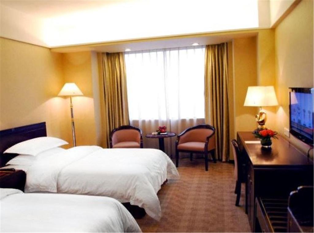Postel nebo postele na pokoji v ubytování Zhongshan International Hotel