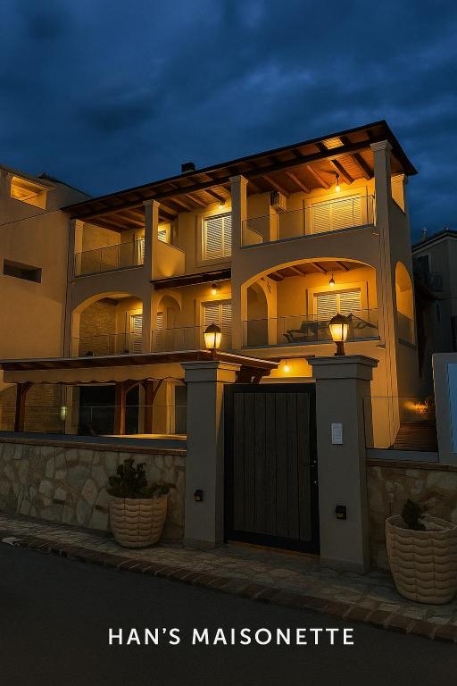 a building with a gate in front of it at night at Han’s Maisonette in Porto Heli
