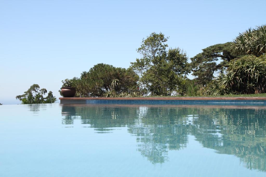 a pool of water with trees in the background at Quinta Vale da Roca in Sintra