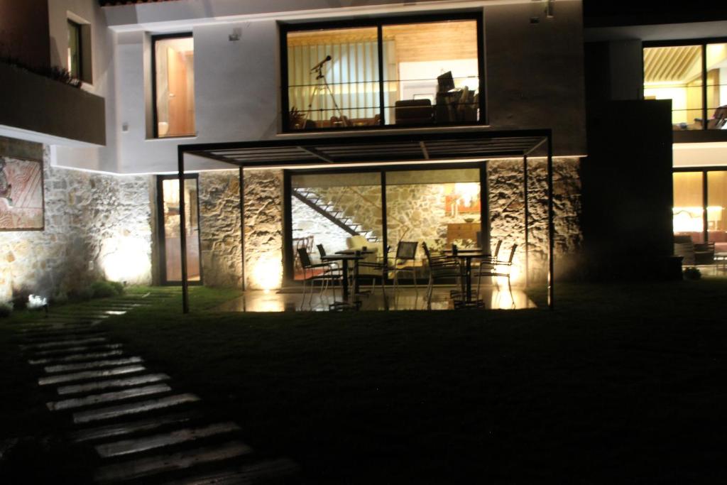 a large building with a table and chairs in it at Quinta Vale da Roca in Sintra