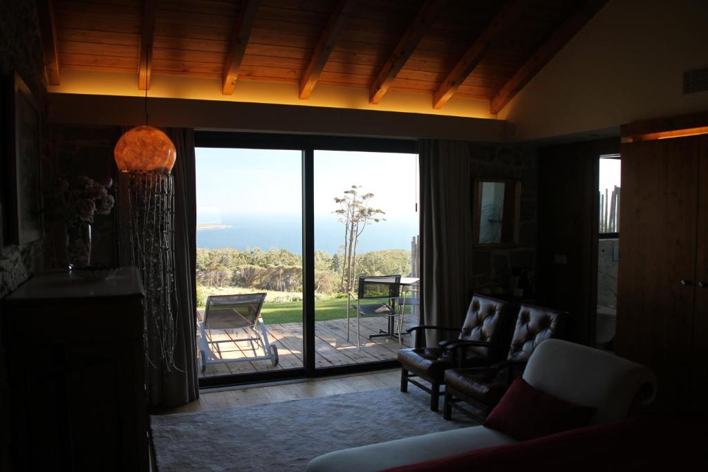 a living room with a large sliding glass door at Quinta Vale da Roca in Sintra