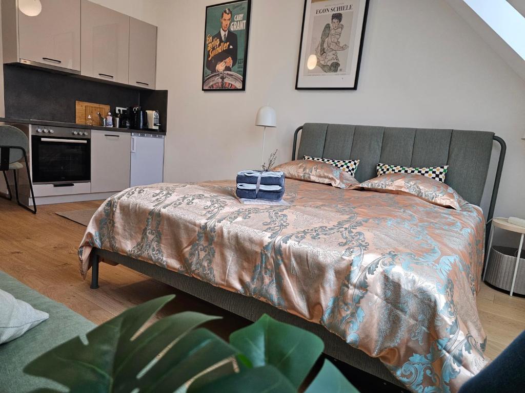 a bedroom with a bed and a kitchen in it at Private Studio Central Vienna in Vienna