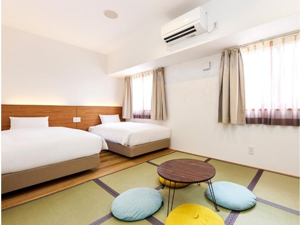 a hotel room with two beds and a table at Smile Hotel Miyakojima - Vacation STAY 93494v in Miyako Island