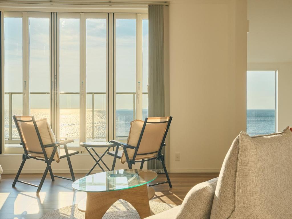 a living room with chairs and a glass table at Ansolas-Villa - Vacation STAY 54282v in Tusi