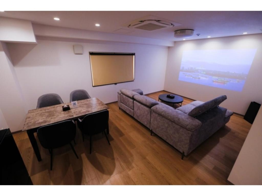 a room with a couch and a table and a screen at HOTEL ALL IN Kumamoto - Vacation STAY 55117v in Hanabatachō