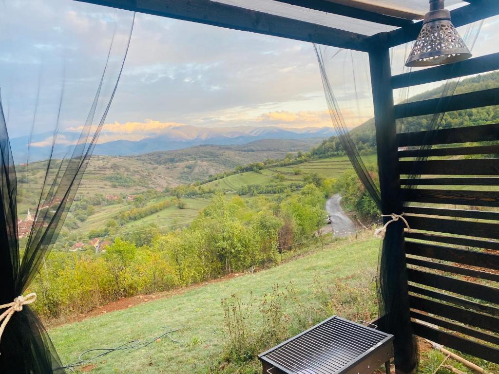 a view from a gazebo with a view of the mountains at Panorama Lupilor in Coleşti