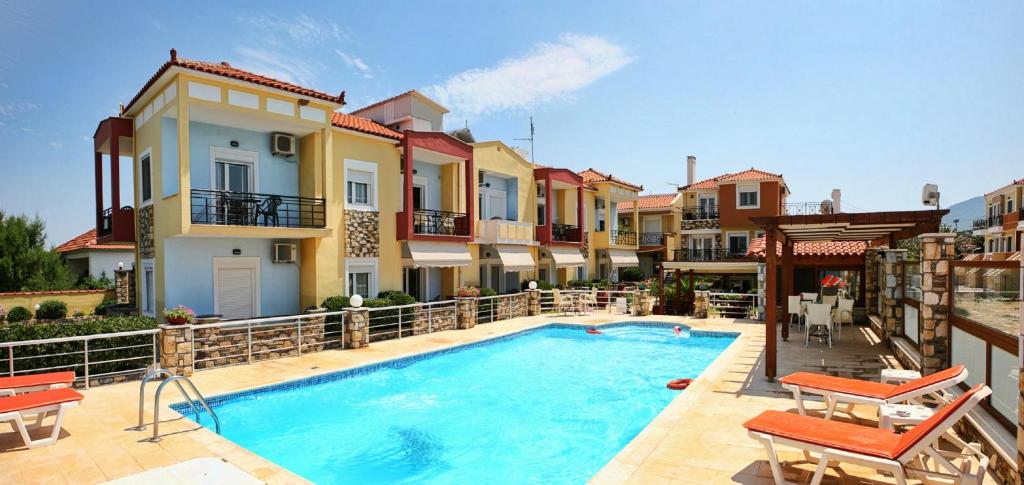 a swimming pool in the middle of a house at Gera Bay Studios And Apartments in Apidias Lakos