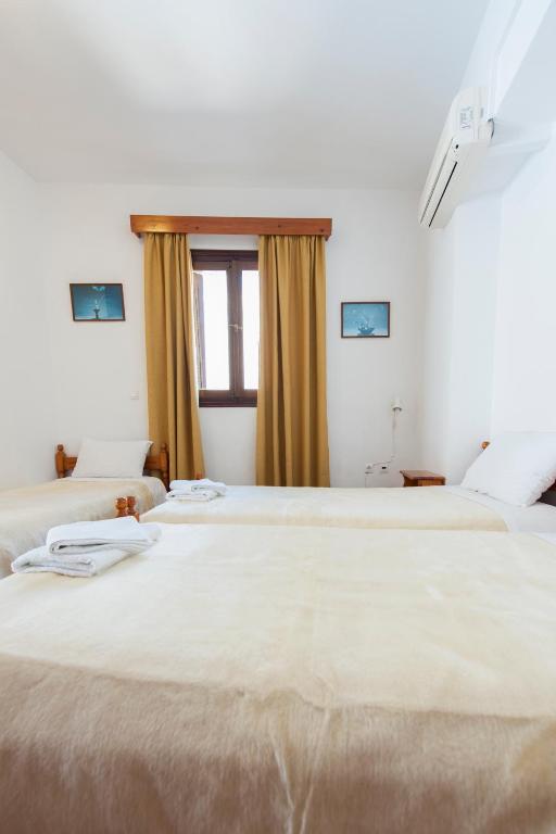 A bed or beds in a room at Stavros Pension