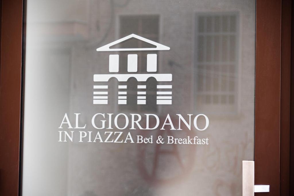 a sign on a glass door with a building at Al Giordano in Piazza in Foggia