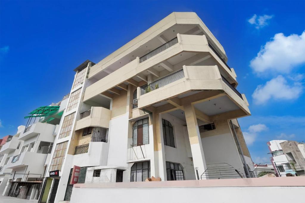 a white building with balconies on top of it at SPOT ON Hotel prayag villa in Allahābād
