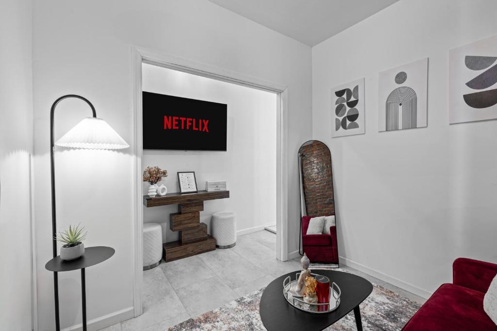 a living room with a couch and a table at NYC cozy & stylish 1 Bed Apt perfect for 4 guest in West New York