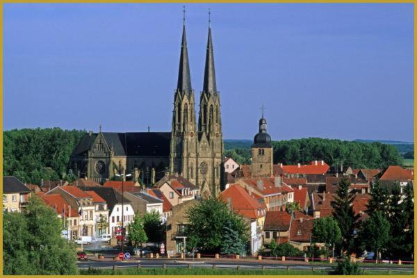 a city with a church and a town with houses at Chez Santa Claus in Sarralbe