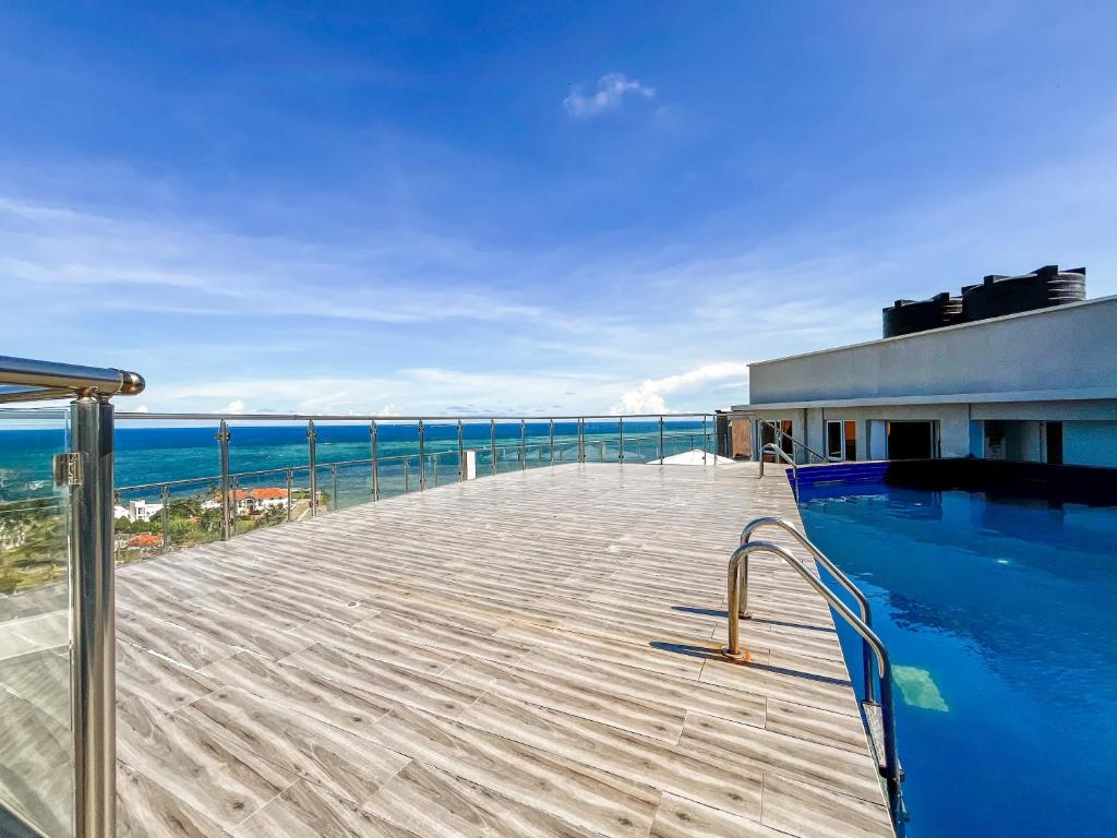 a swimming pool on top of a building with the ocean at Eliana's nyali 3 min to the beach homes in Mombasa