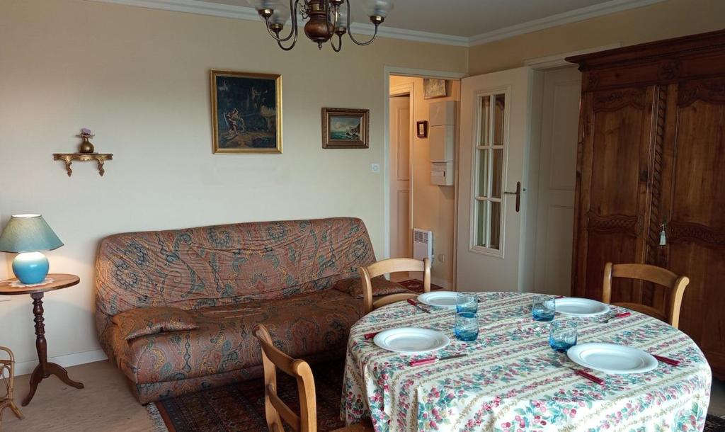 a living room with a table and a couch at Appartement plein centre à 300m de la plage in Le Touquet-Paris-Plage
