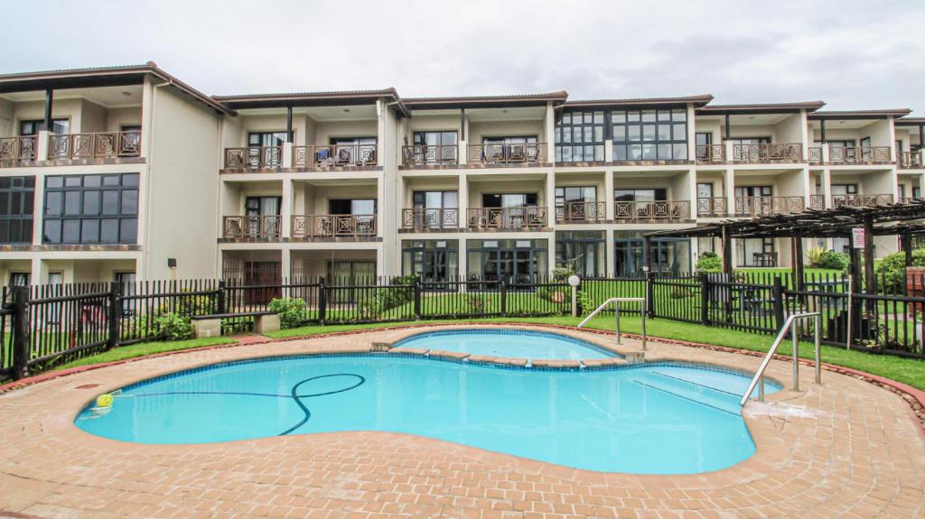 an image of an apartment building with a pool at Topanga 52 in Uvongo Beach