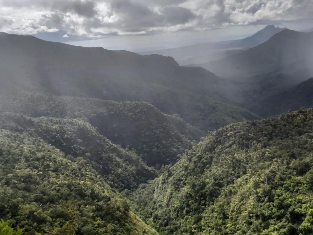 a view of a mountain valley with clouds in the sky at Lakaz in Port Louis