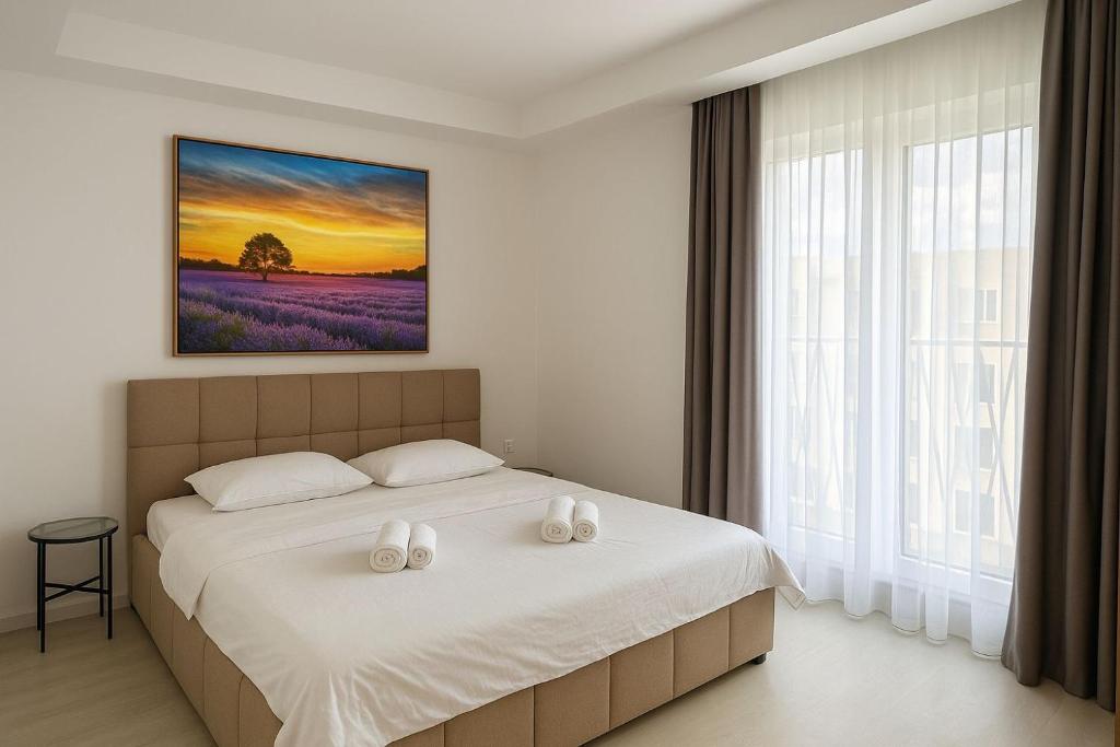 a bedroom with a bed with two white pillows at Lunara Studio #freeparking #pool in Tunari