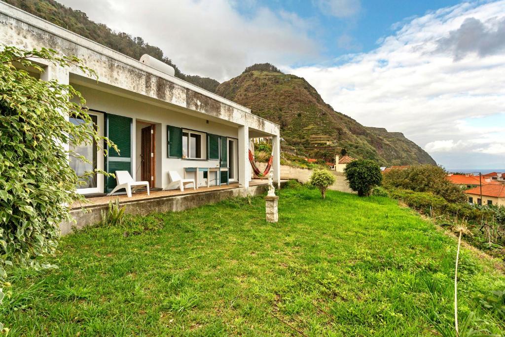 a house with a mountain in the background at Blissful Haven - Soulful Stays in Ilhéu Mole