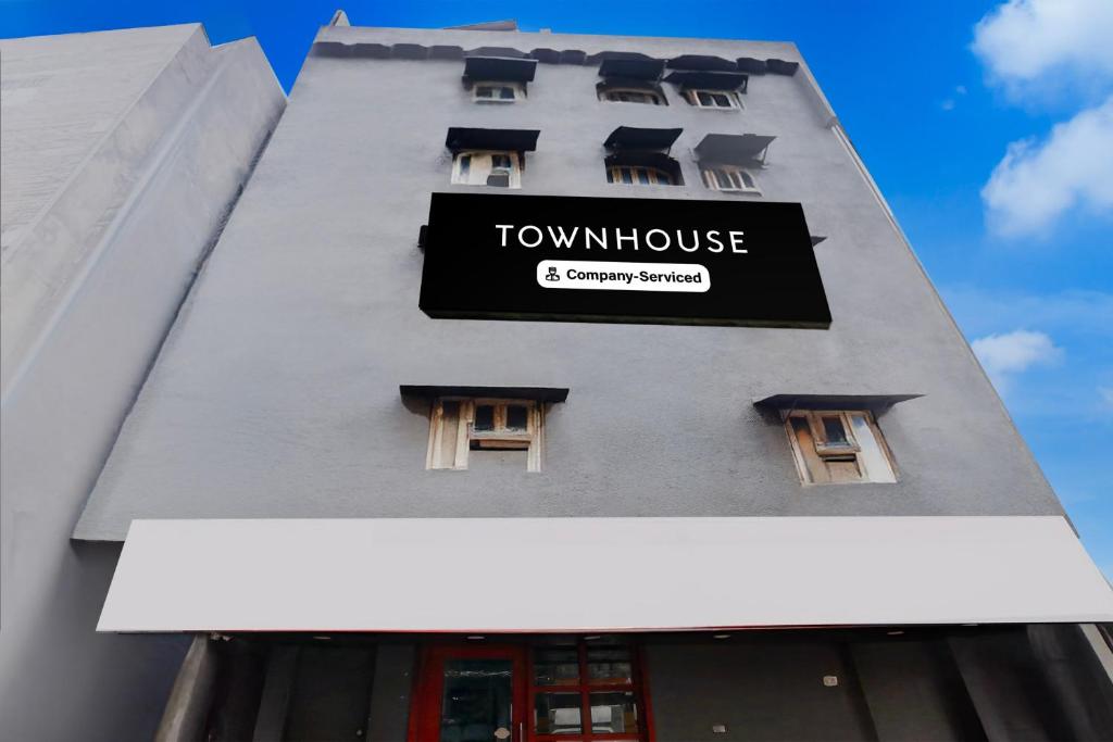a building with a sign on the side of it at Townhouse Nagpur Junction Formerly Hotel Woodland in Nagpur