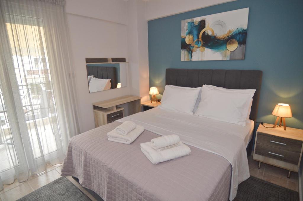 a bedroom with a bed with two towels on it at Naya Lux Apt in Kastoria