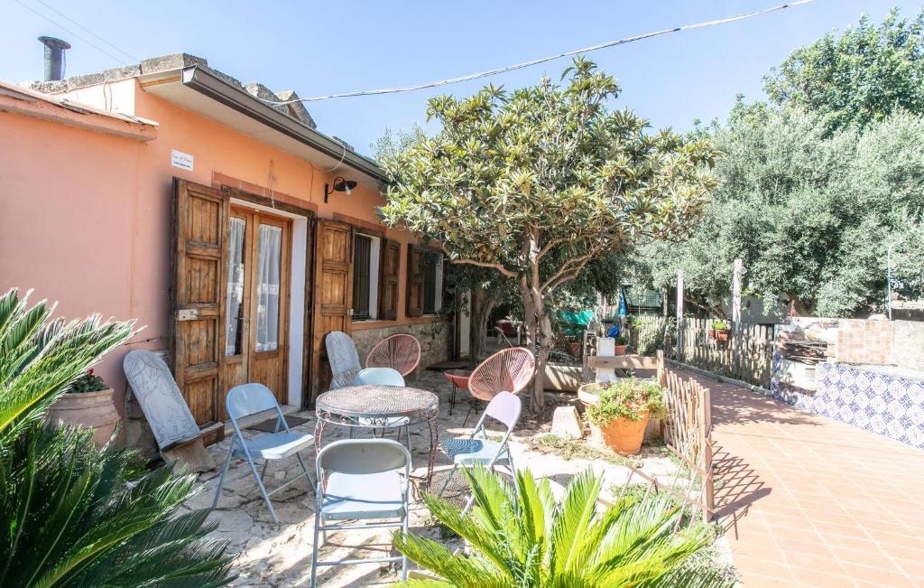 a patio with chairs and a table in front of a house at Pet Friendly Home In Ragusa With Wifi in Ragusa