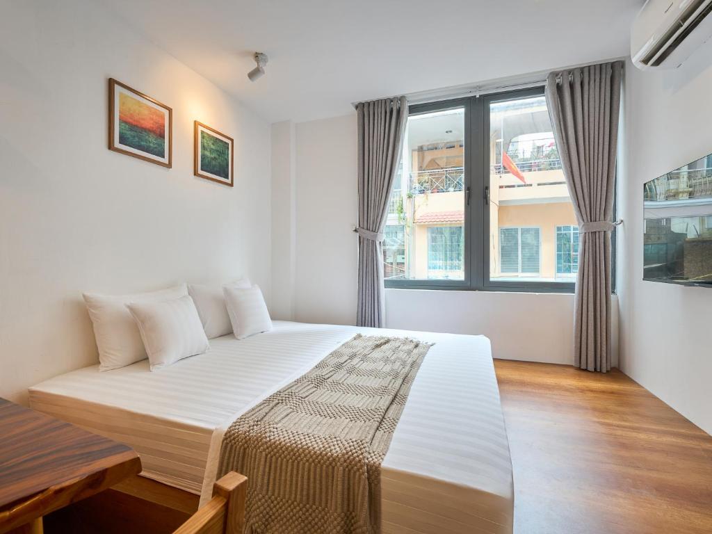 a bedroom with a bed and a large window at DIAMOND Matrix One in Heart of District 1-Luxury Living-Coffee Shop Above in Ho Chi Minh City