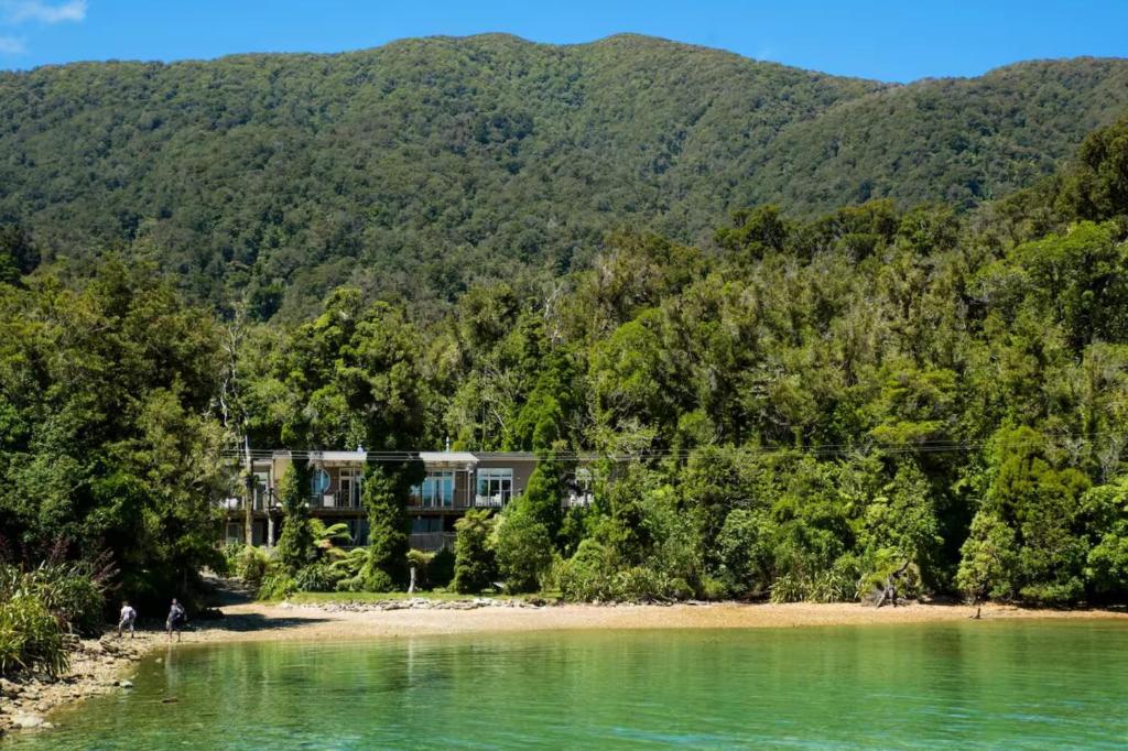 a house on the shore of a body of water at 5-bedroom waterfront home in Endeavour Inlet