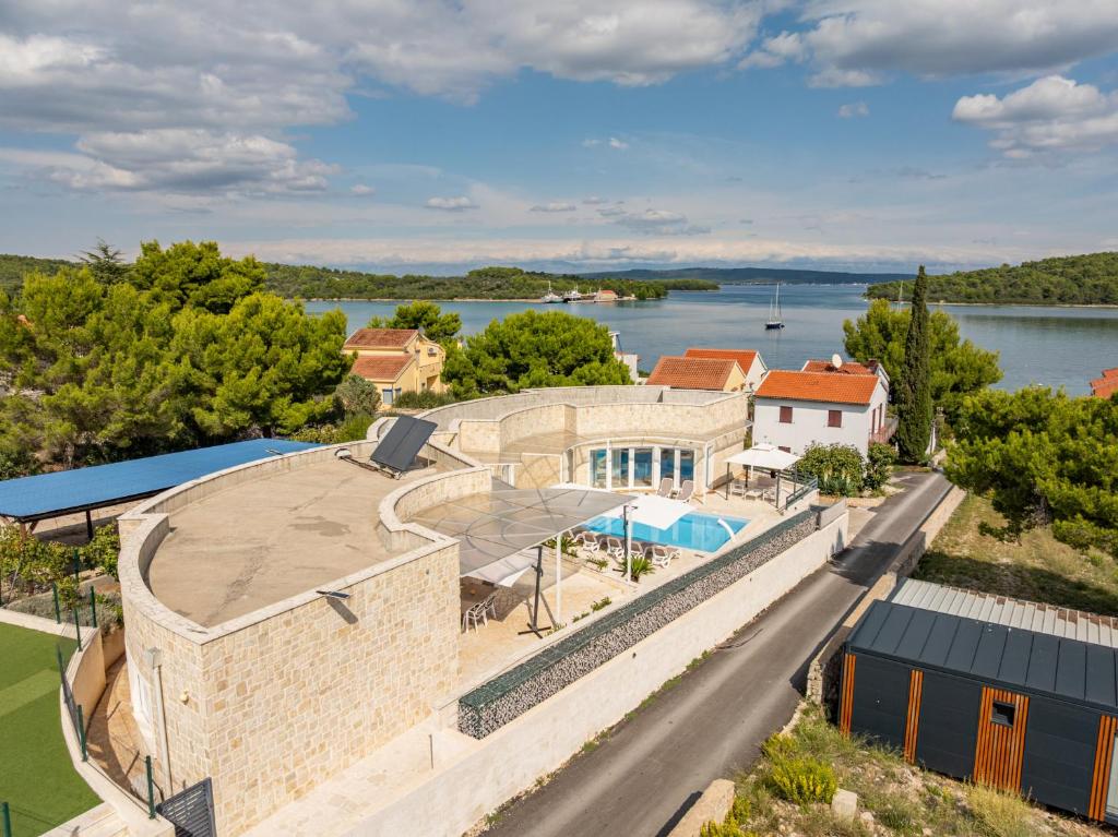an aerial view of the house and the water at Unique luxury Villa Feriatum Lissa in Ždrelac