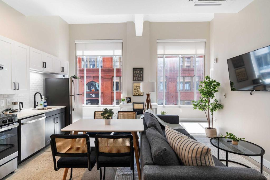 a living room with a couch and a table at Spacious 2BR CozySuites OTR Downtown #12 in Cincinnati