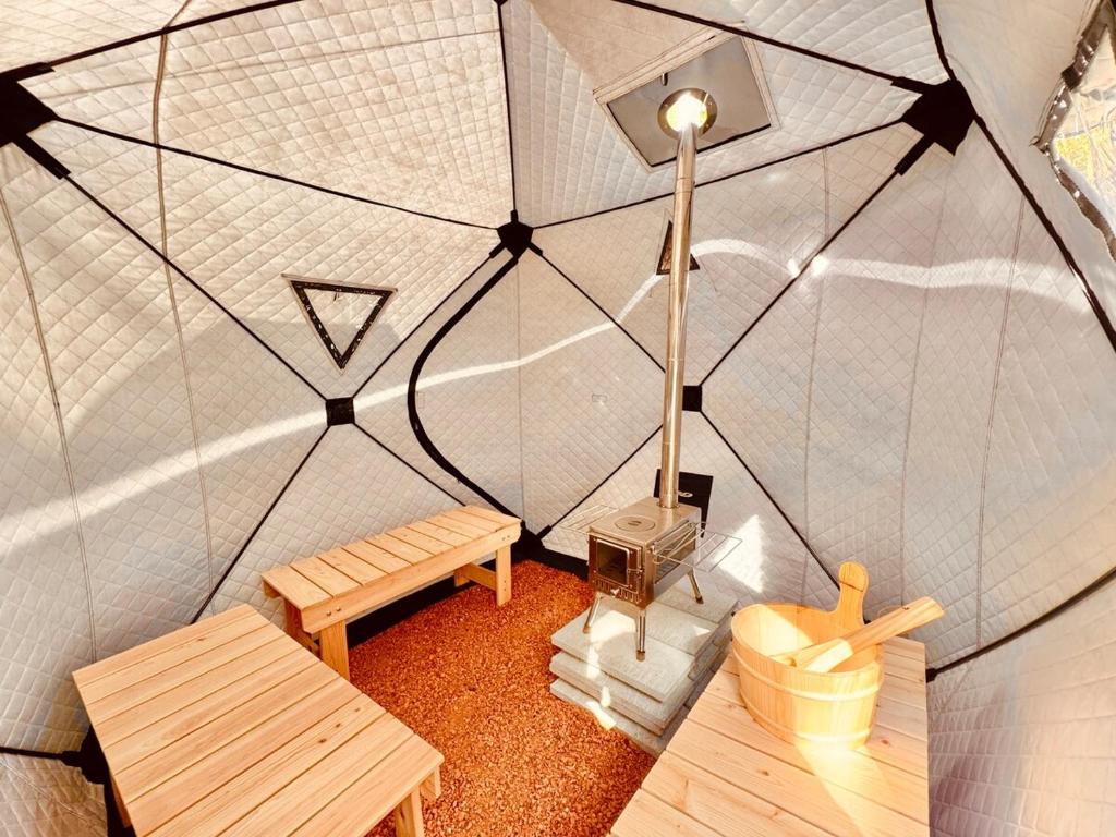 a miniature tent with a bench and a street light at Ocean House NUI in Katakai