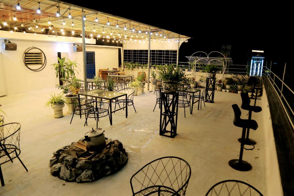 a large patio with tables and chairs and lights at Retro Homestay Hạ Long in Ha Long